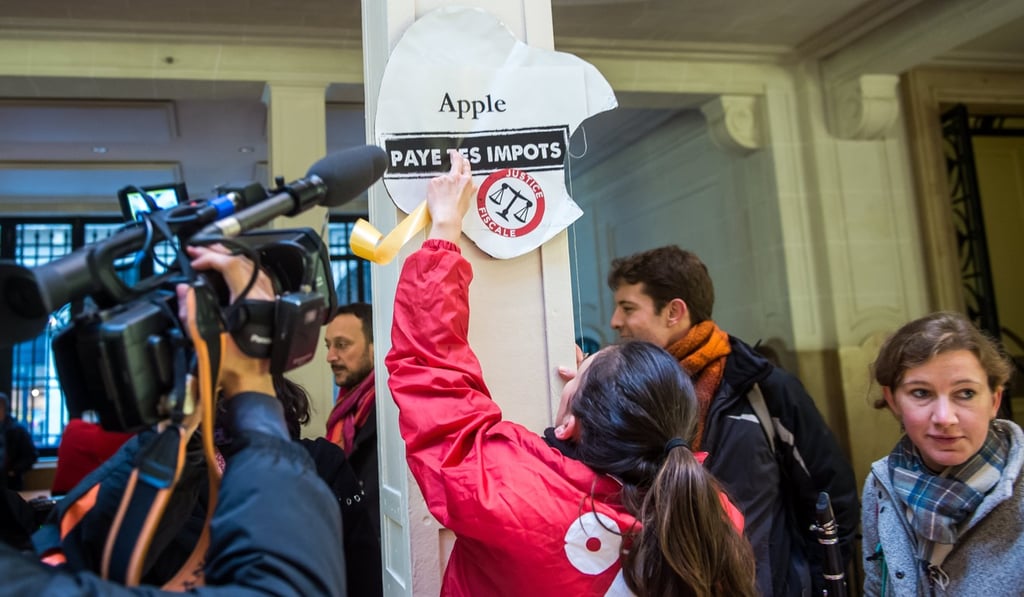 Activists of Attac, an anti-globalisation organisation occupy an Apple store in the French capital. Photo: EPA Activists of Attac, an anti-globalisation organisation occupy an Apple store in the French capital. Photo: EPA