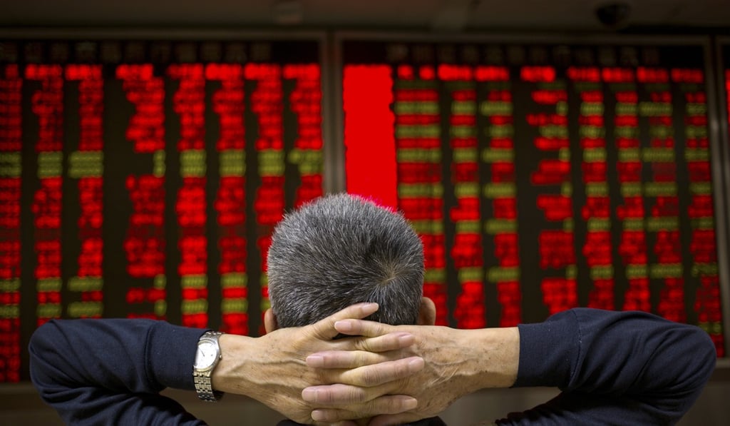 A Chinese investor monitors stock prices at a brokerage house in Beijing. Photo: AP