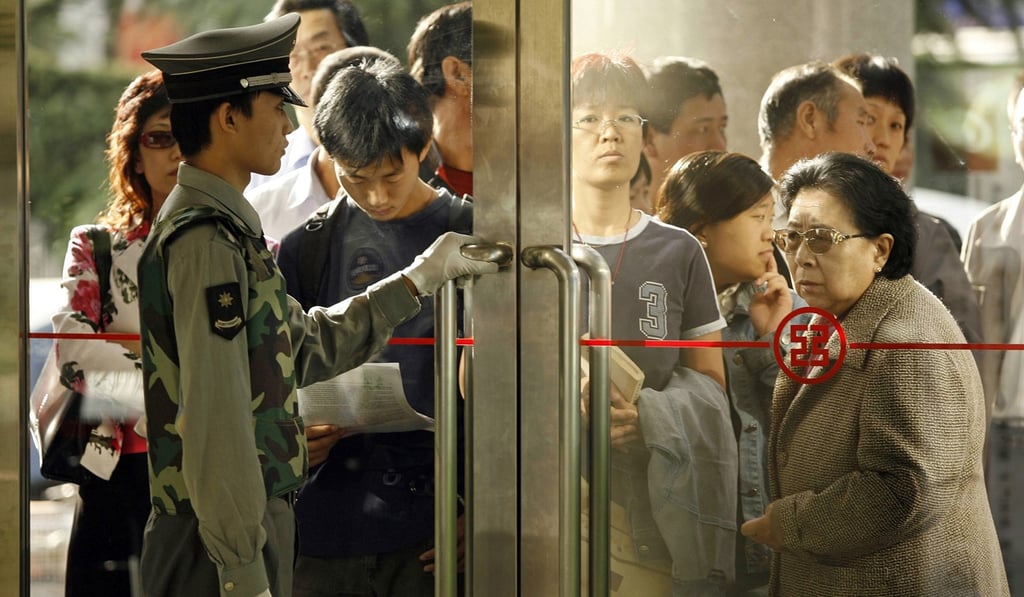 Customers queue as they wait for a branch of the Industrial and Commercial Bank of China (ICBC) to open for morning trade. Photo: AFP