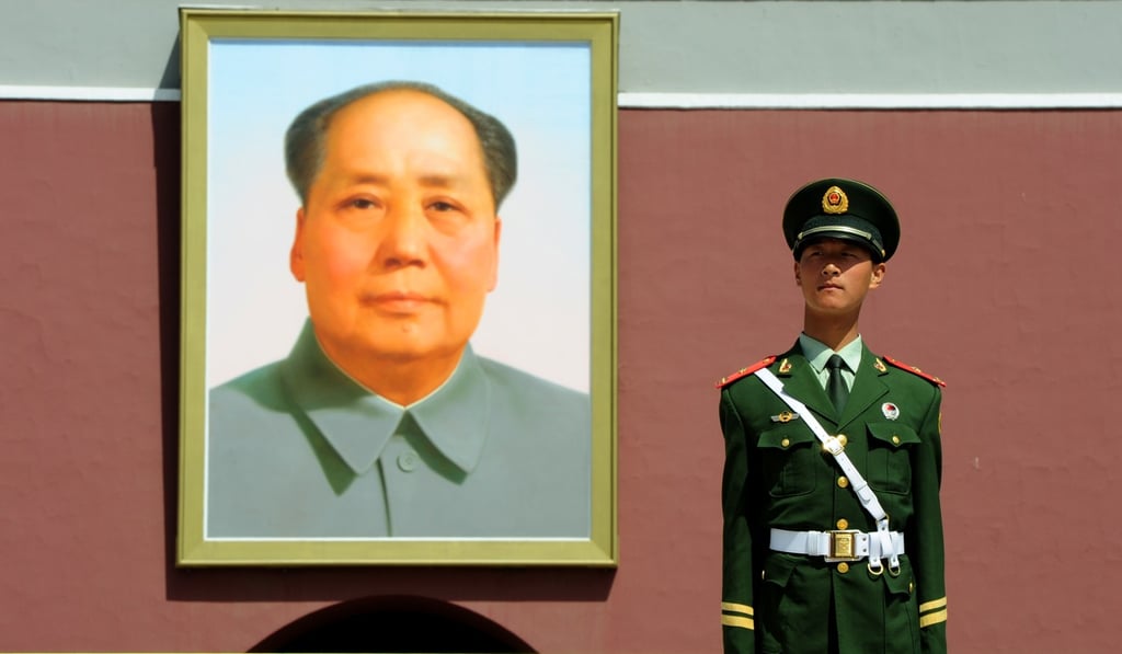A Chinese military policeman stands guard in Tiananmen Square next to a portrait of Mao Zedong. Photo: AFP