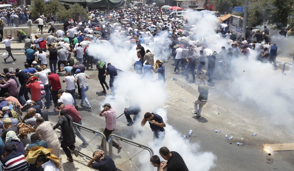 In this July 21 file photo, Palestinians run away from tear gas thrown by Israeli police officers outside Jerusalem’s Old City. Photo: AP In this July 21 file photo, Palestinians run away from tear gas thrown by Israeli police officers outside Jerusalem’s Old City. Photo: AP