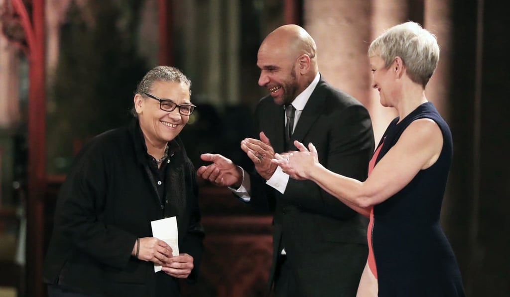 DJ Goldie, centre and Maria Jane Balshaw, Director of the Tate, applaud artist Lubaina Himid, left, after she was awarded the Turner Prize for 2017 at Hull Minster, in Hull, England, on Tuesday. Photo: AP