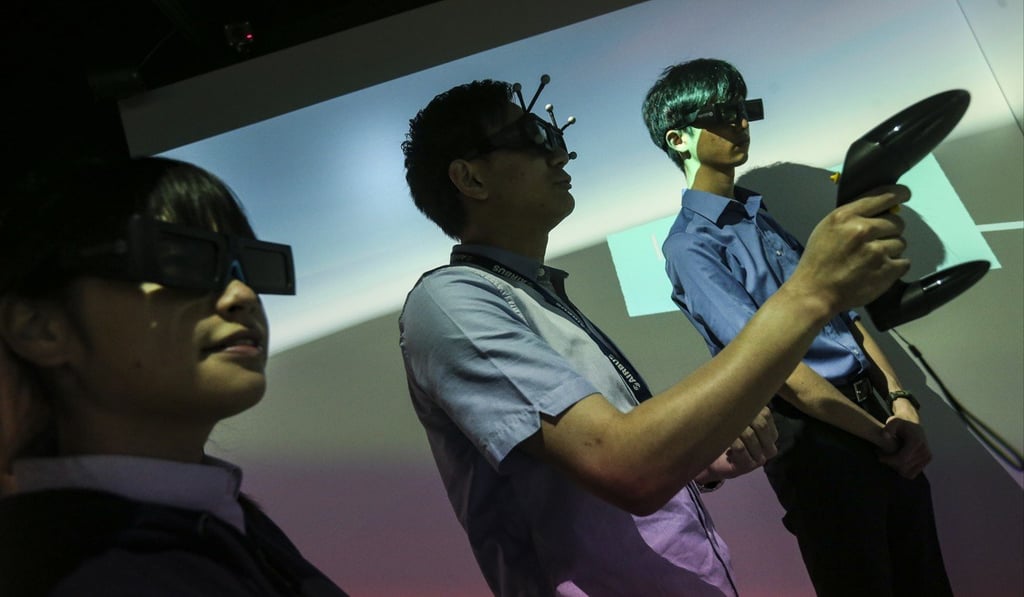 Students try out an augmented reality/virtual reality simulation system to help train them for aircraft repair and buildings maintenance, as developed by the Institute of Vocational Education engineering teaching team in Tsing Yi. Photo: K.Y. Cheng