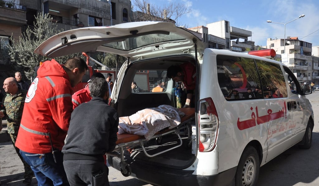 Emergency services load a victim into an ambulance at the site of a car bomb explosion in a predominantly pro-government neighbourhood of the central Syrian city of Homs. Photo: AFP