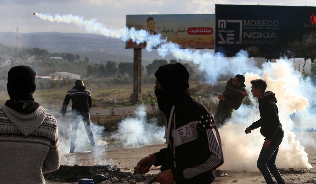 A Palestinian protester throws back a tear gas canister at Israeli soldiers during clashes in the West Bank city of Nablus. Photo: Xinhua A Palestinian protester throws back a tear gas canister at Israeli soldiers during clashes in the West Bank city of Nablus. Photo: Xinhua