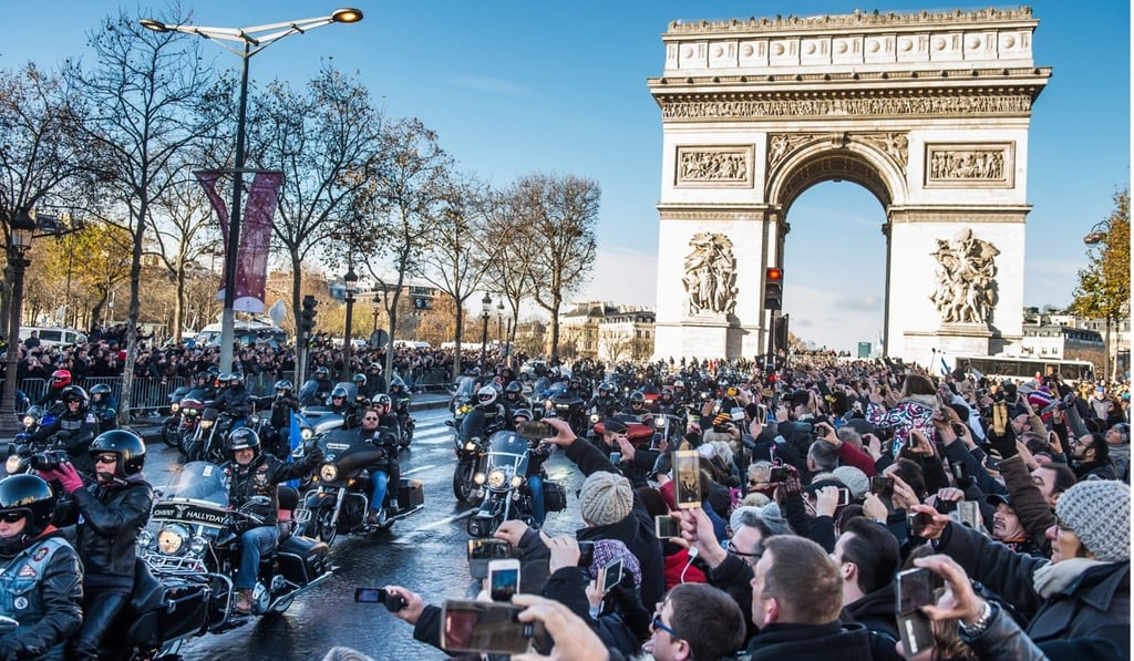 Bikers riding Harley-Davidson motorcycles escort the funeral procession of French singer Johnny Hallyday along the Champs Elysees in Paris. Photo: EPA