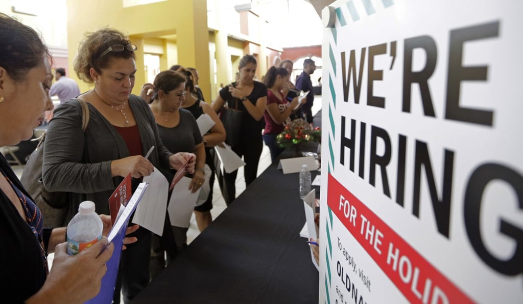 Jobseekers wait in line to apply for part-time, full-time or seasonal positions at a job fair held at Dolphin Mall in Sweetwater, Florida. Photo: AP
