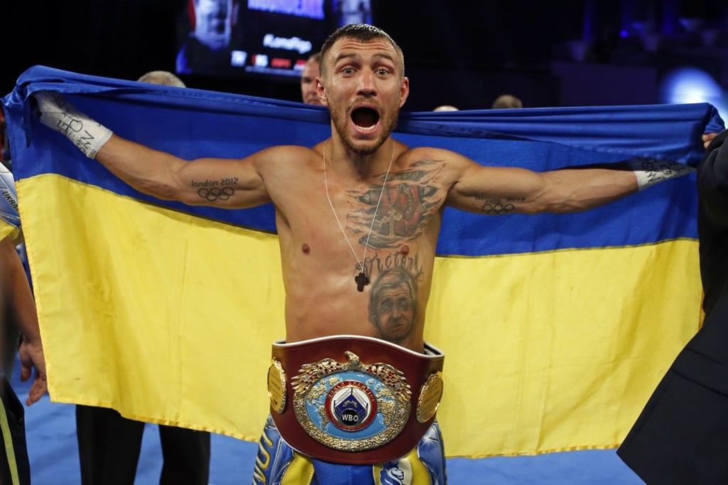 Lomachenko celebrates after defeating Rigondeaux. Photo: AP