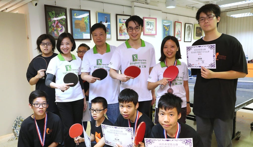 The volunteers led the teams of children in playing table tennis at the one-day tournament. Photo: K. Y. Cheng