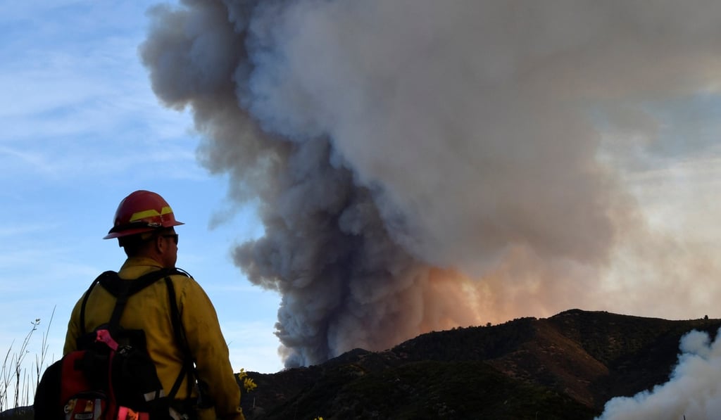 A firefighter looks out towards the Thomas Fire, a massive fire during north of Ojai, California. Photo: Reuters