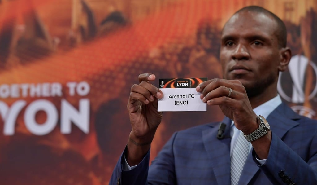 Former French international Eric Abidal shows the slip of Arsenal during the Europa League draw.