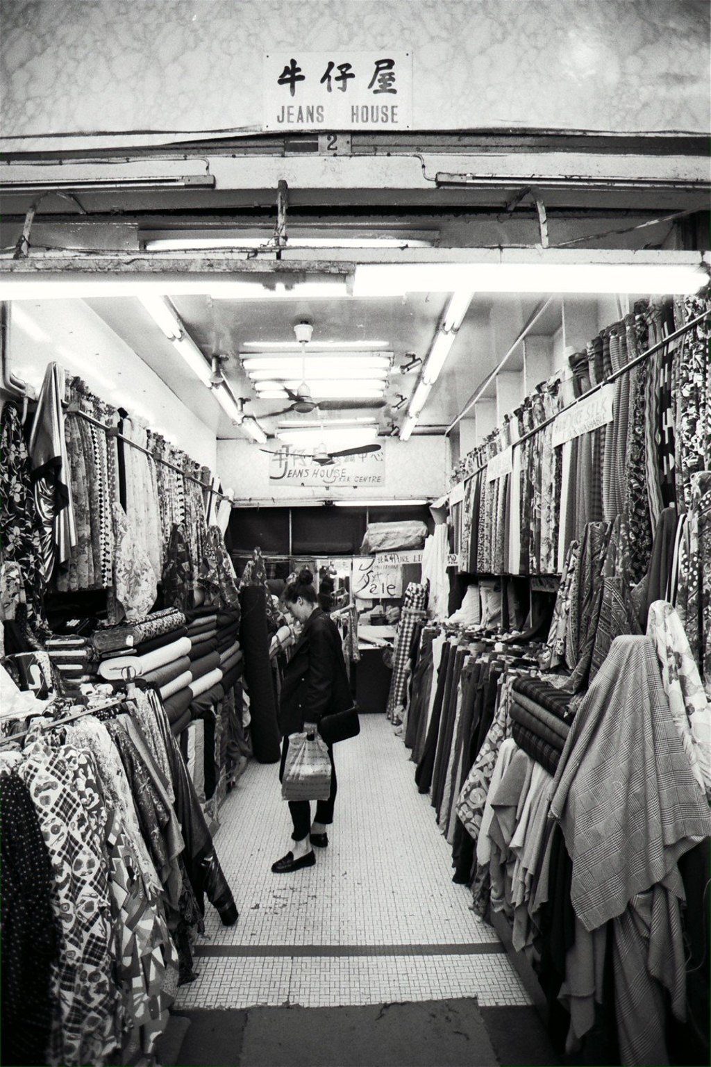 A shopper in a cloth shop on Wing On Street, then known locally as Cloth Street, in Central in 1992. Photo: SCMP A shopper in a cloth shop on Wing On Street, then known locally as Cloth Street, in Central in 1992. Photo: SCMP