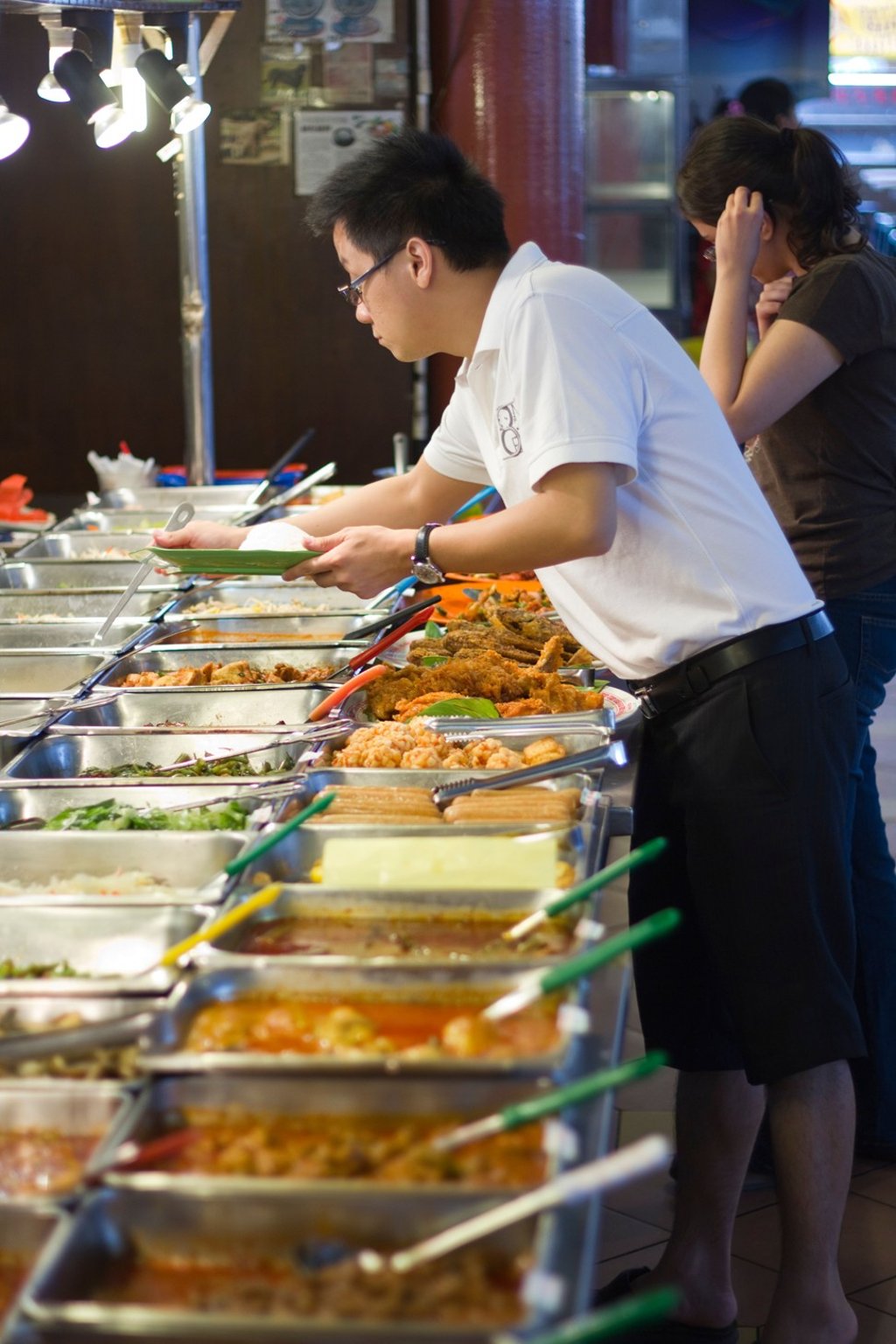 Man selecting food at the Ming Tien Food Court. Photo: Alamy