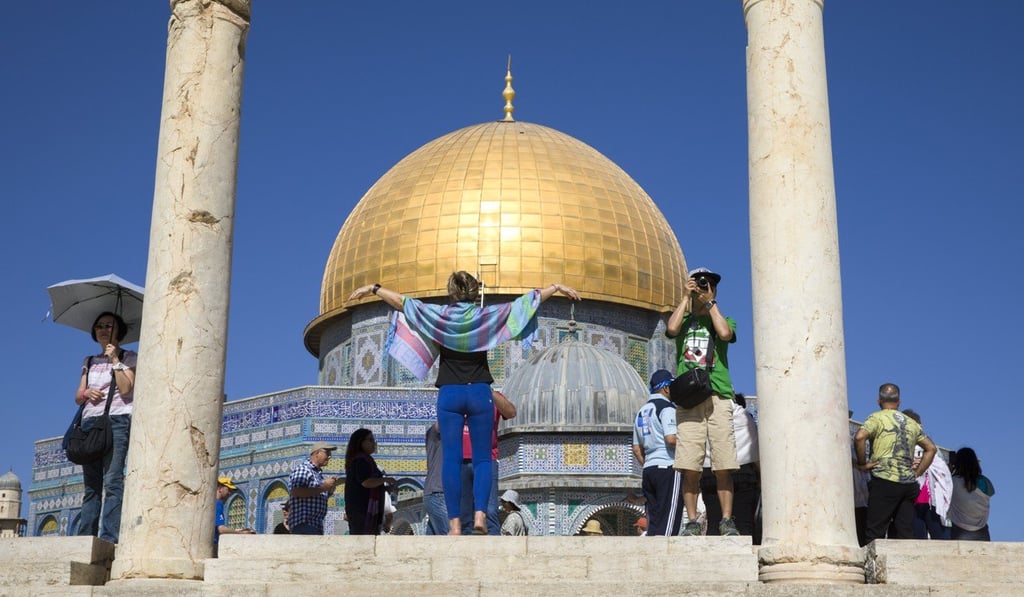 A group of tourists stand near the distinctive golden Dome of the Rock as they tour the Temple Mount, or Haram el-Sharif as it is known to Arabs, in Jerusalem's Old City in July. The rock over which the shrine was built is sacred to both Muslims and Jews. Photo: EPA-EFE