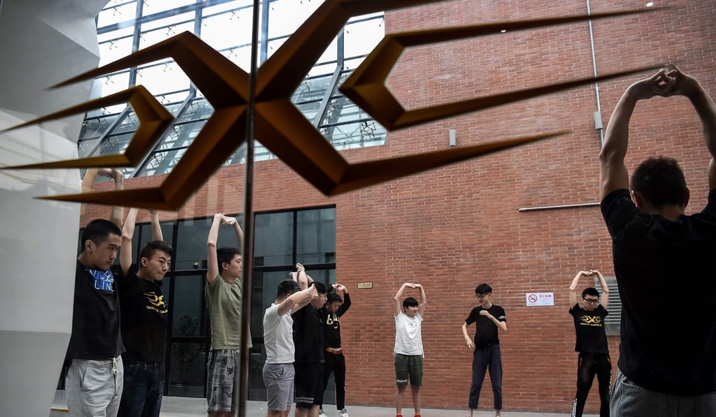 Gamers from various e-sports teams exercise during training for the League of Legends World Championship in Shanghai in September. Photo: AFP