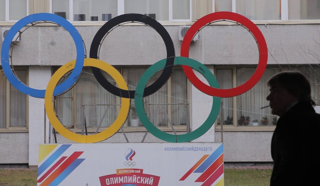 A man smokes near Olympic rings placed in the courtyard of the Russian Olympic Committee headquarters in Moscow. Russia has been banned from sending a team to the Winter Games. Photo: Reuters