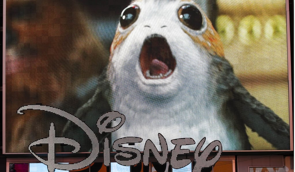 An advertisement for the new Star Wars film plays on a screen as the Disney logo is displayed outside the Disney Store in Times Square, New York. Photo: Agence France-Presse