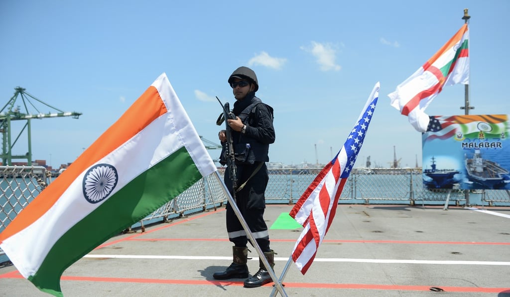 An Indian sailor stands guard on the deck of the INS Shivalik in July during the inauguration of joint naval exercises with the US and Japan in Chennai. India began holding naval exercises with the two nations off its south coast on July 10, seeking to forge closer military ties to counter growing Chinese influence in the region. Photo: AFP