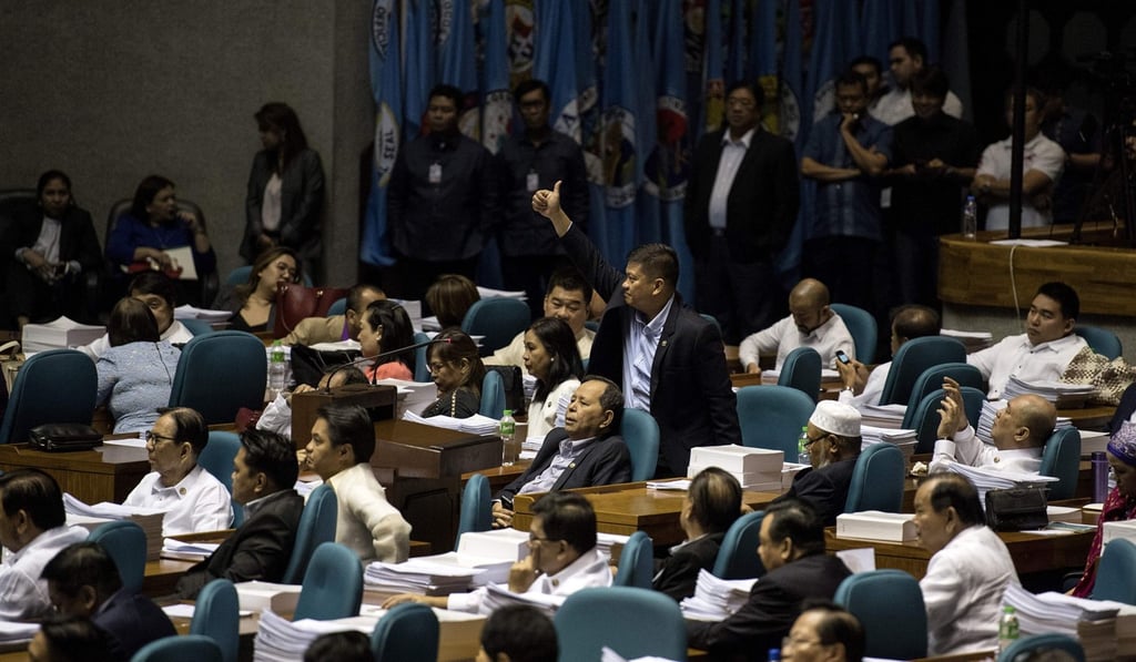 A congressman gives a thumbs up as he votes for the extension of Martial Law in Mindanao. Photo: AFP