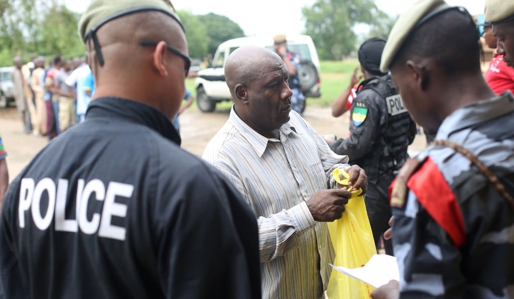 Police question a detained Muslim trader. Photo: AFP Police question a detained Muslim trader. Photo: AFP