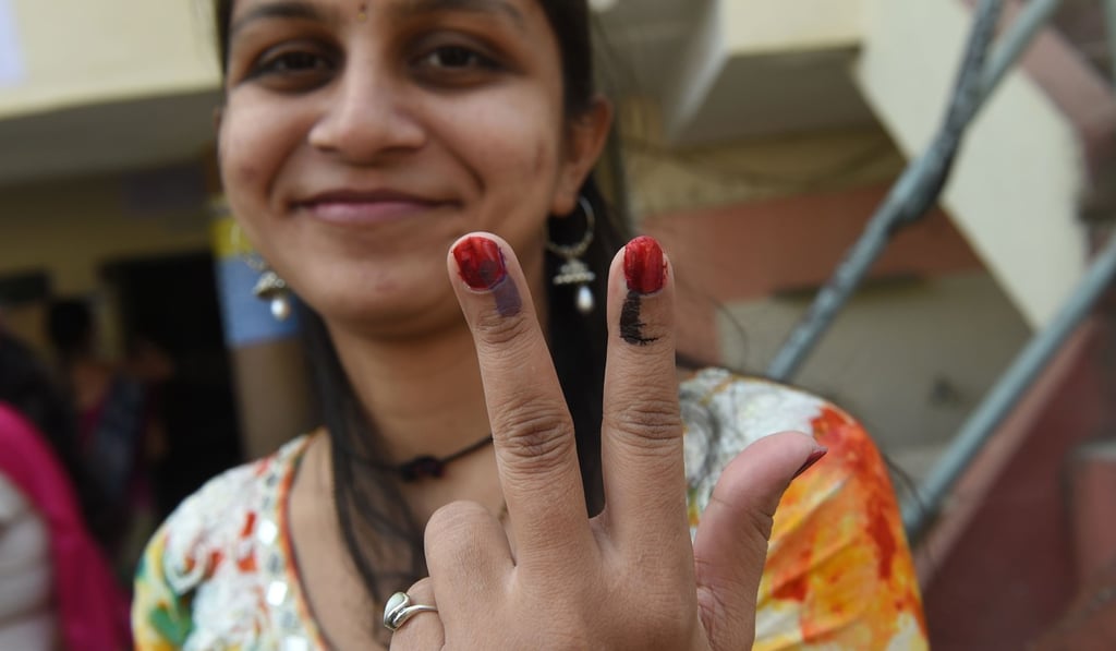 A voter shows her inked fingers after voting at a re-polling centre at Nava Naroda on the outskirts of Ahmedabad. Photo: AFP A voter shows her inked fingers after voting at a re-polling centre at Nava Naroda on the outskirts of Ahmedabad. Photo: AFP