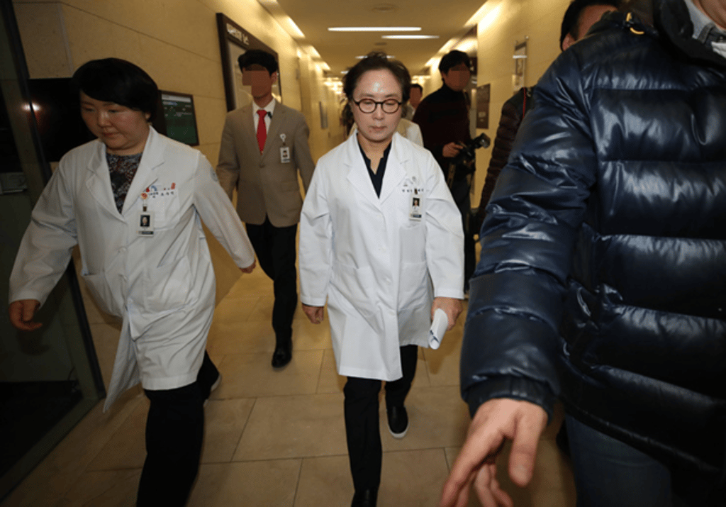Ewha Womans University Medical Centre President Chung Hye-won, centre, leaves a press conference after issuing an apology. Photo: Yonhap Ewha Womans University Medical Centre President Chung Hye-won, centre, leaves a press conference after issuing an apology. Photo: Yonhap