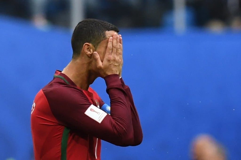 Portugal forward Cristiano Ronaldo hides his face during the 2017 Confederations Cup match against New Zealand at the Saint Petersburg Stadium. Photo: AFP