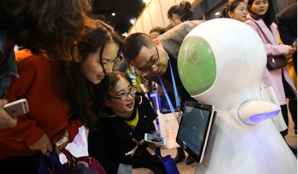 People interact with a robot at the fourth World Internet Conference in Wuzhen, China on December 2. China is leading Asia in a number of barometers related to its preparations for artificial intelligence, including funding for AI-related start-ups. Photo: Xinhua