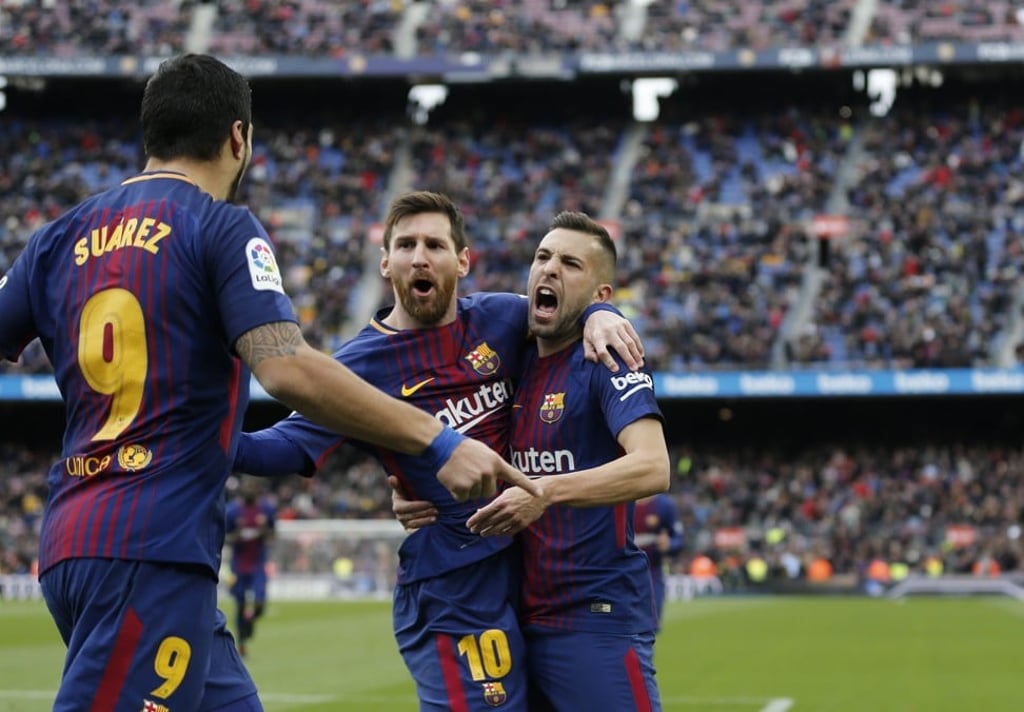 Lionel Messi (centre) and Jordi Alba (right) have combined to devastating effect this season. Photo: AFP
