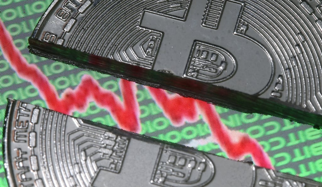 Broken representation of the bitcoin virtual currency, placed on a monitor that displays stock graph and binary codes, are seen in this illustration picture, on December 21, 2017. Photo: Reuters