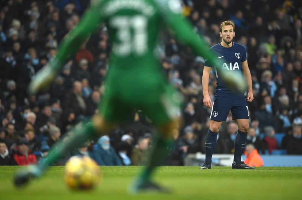 Ederson (left) passes the ball by Tottenham striker Harry Kane looks on. Photo: AFP