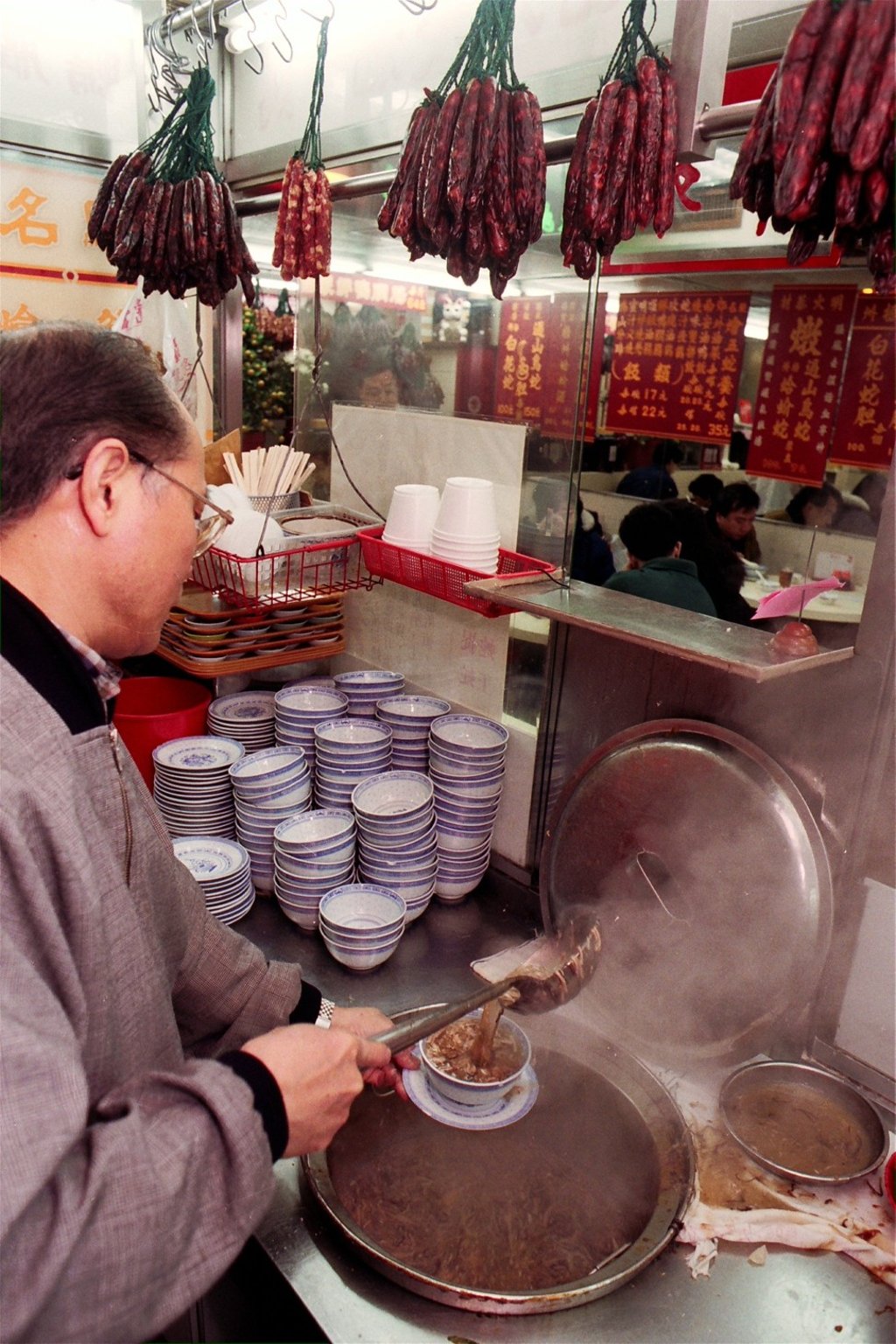 A vendor in Hong Kong prepares snake broth, a dish the Chinese serve in winter to cure coughs and sneezes, and keep the body warm. Picture: SCMP