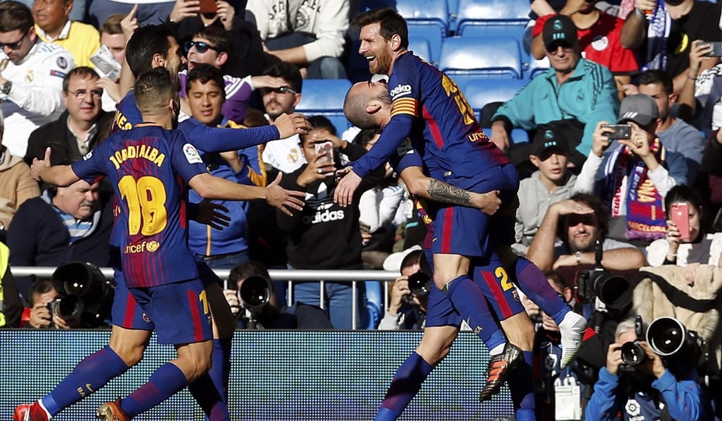 Barcelona's Aleix Vidal celebrates with Lionel Messi (right) after scoring his side's third goal against Real Madrid. Photo: AP