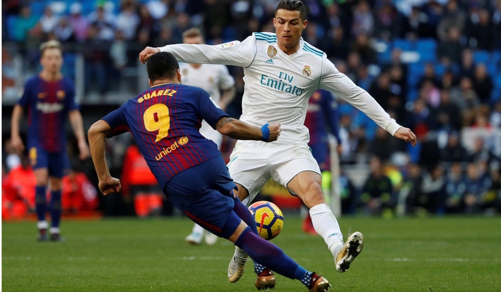 Barcelona’s Luis Suarez challenges Real Madrid’s Cristiano Ronaldo. Photo: Reuters