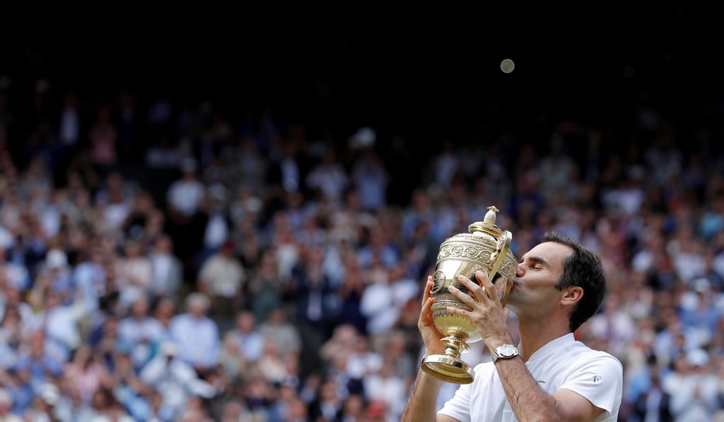 Switzerland's Roger Federer kisses the trophy after winning his eighth Wimbledon title. Photo: Reuters