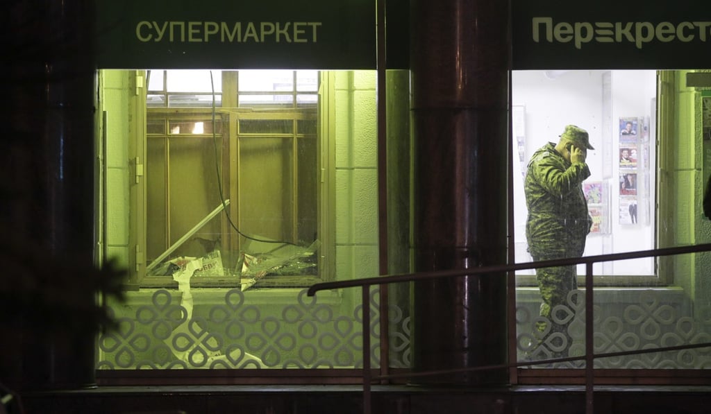 An investigator speaks on the phone inside the St Petersburg supermarket. The device, which was rigged with shrapnel, was left in a luggage storage area. St Peterburg suffered a subway bombing earlier in the year. Photo: AP