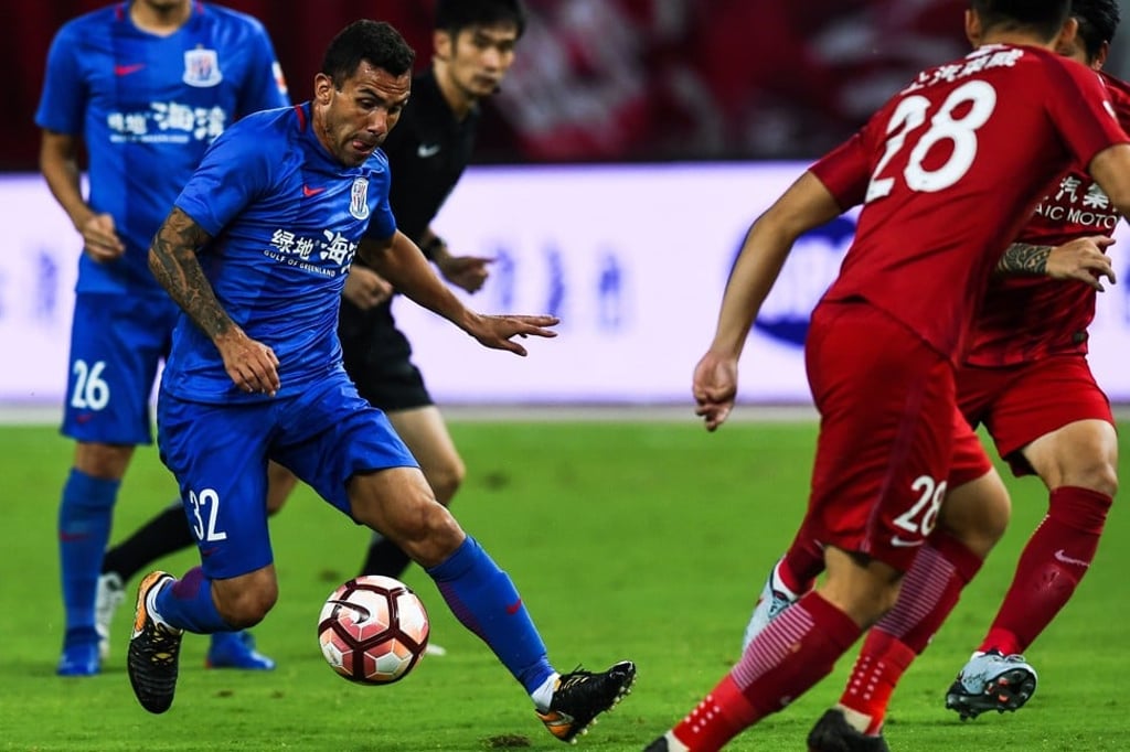 Shanghai Shenhua's Carlos Tevez dribbles in the Shanghai derby. Photo: AFP