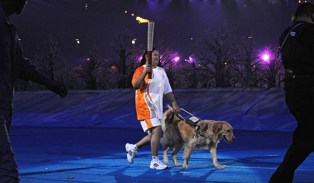 Ping Yali with Lucky, her guide dog, at the 2008 Beijing Paralympic Games. Photo: AFP