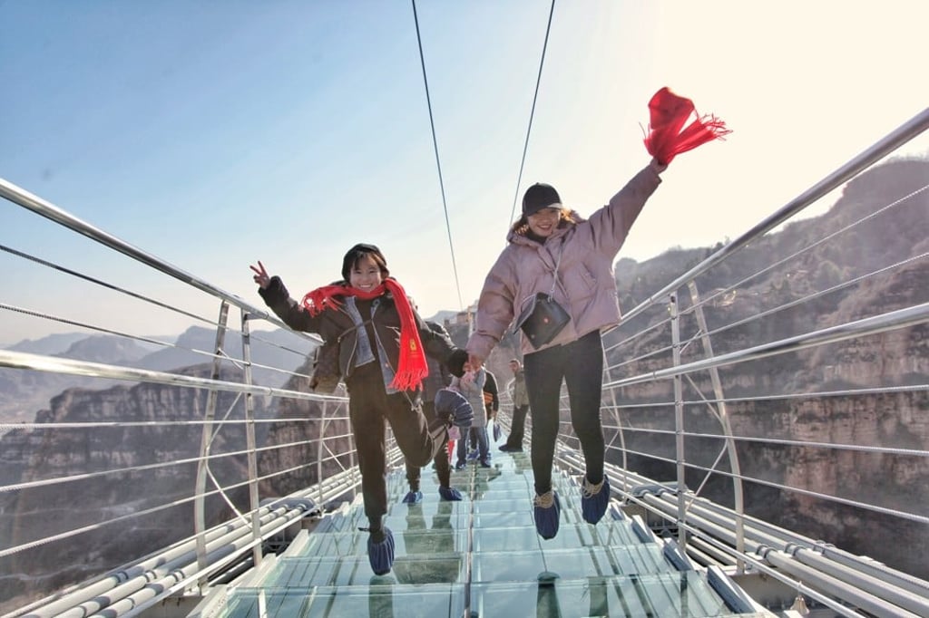 Tourists walk across the bridge at Hongyagu Scenic Area in Pingshan County, Hebei province. Photo: Xinhua Tourists walk across the bridge at Hongyagu Scenic Area in Pingshan County, Hebei province. Photo: Xinhua