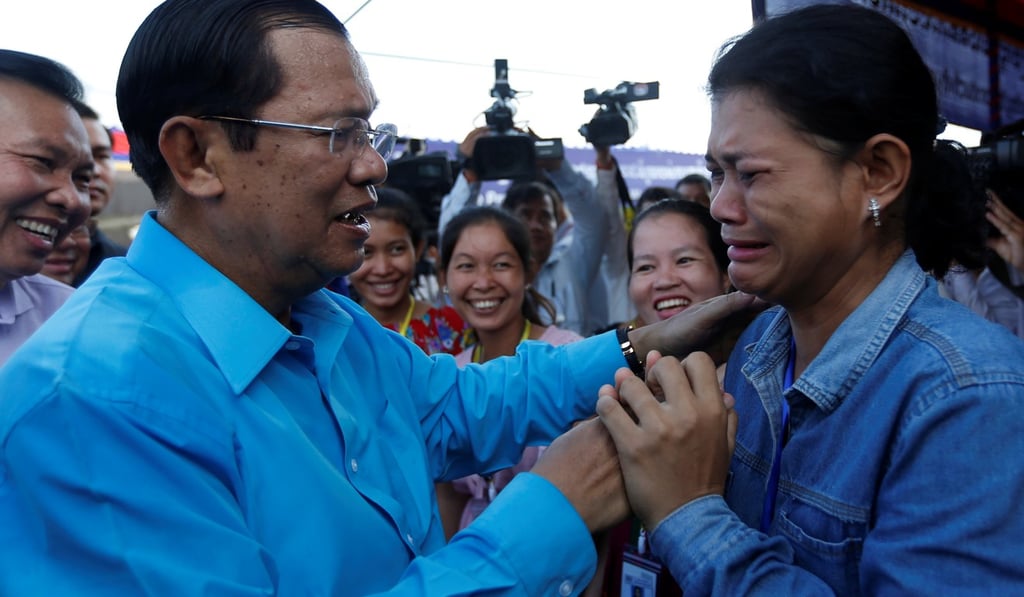 A garment worker cries as she meets Cambodian Prime Minister Hun Sen, on the outskirts of Phnom Penh, on November 8. In November, Cambodia’s Supreme Court dissolved the country’s main opposition party and banned more than 100 of its politicians from office for five years. Photo: Reuters