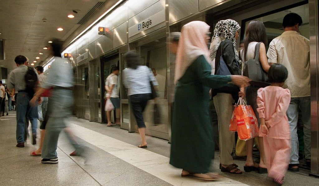People board a train in Singapore. Photo: AFP
