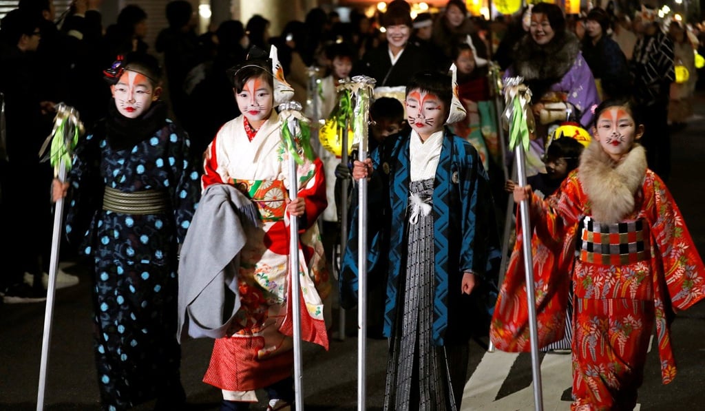 Participants dressed up as foxes parade for the first prayer of the New Year in Tokyo. Photo: Reuters