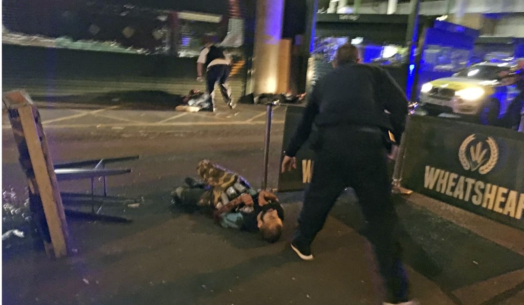 In this image provided by Gabriele Sciotto taken on June 3, 2017, one of the suspects in the London Bridge attack lies on the ground after being shot by police outside Borough Market. The attackers killed three victims by running them down in a van, then stabbed five to death, before police shot all the attackers dead. Photo: AP