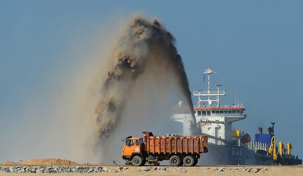 Pumps dredge sand to reclaim land at the site of a Chinese-funded US$1.4 billion reclamation project in Colombo. Photo: AFP Pumps dredge sand to reclaim land at the site of a Chinese-funded US$1.4 billion reclamation project in Colombo. Photo: AFP