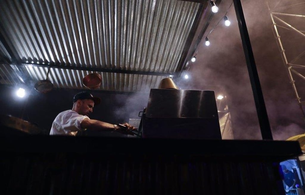 Smoke rises above a cook preparing plates of food using a wood-burning oven at Buenos Aires’s food fair. The flavour is well preserved. Photo: AP Smoke rises above a cook preparing plates of food using a wood-burning oven at Buenos Aires’s food fair. The flavour is well preserved. Photo: AP