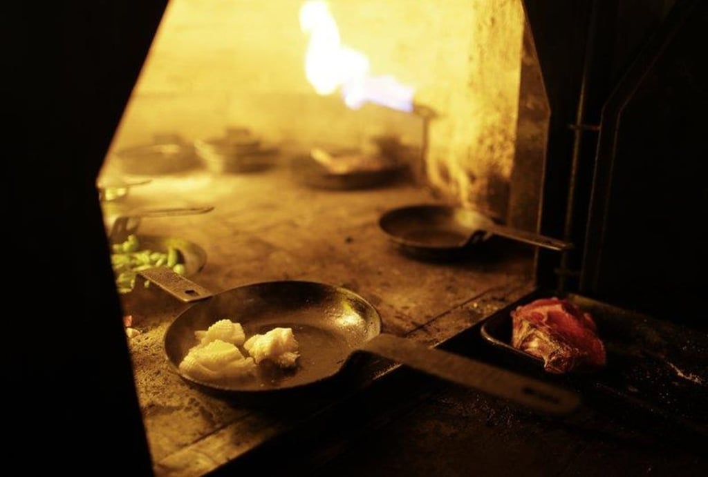Calamari cooks inside a wood-burning oven at Proper restaurant in Buenos Aires, Argentina. Photo: AP Calamari cooks inside a wood-burning oven at Proper restaurant in Buenos Aires, Argentina. Photo: AP