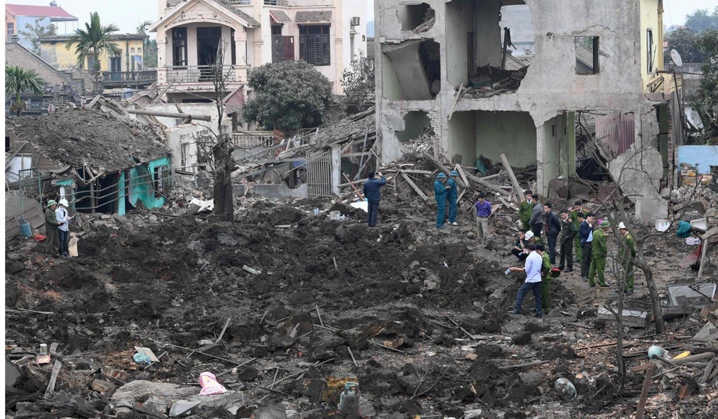 Soldiers and rescuers inspect the crater left by an ammunition explosion that destroyed several houses east of Vietnam’s capital, Hanoi, early on Wednesday. Photo: Agence France-Presse