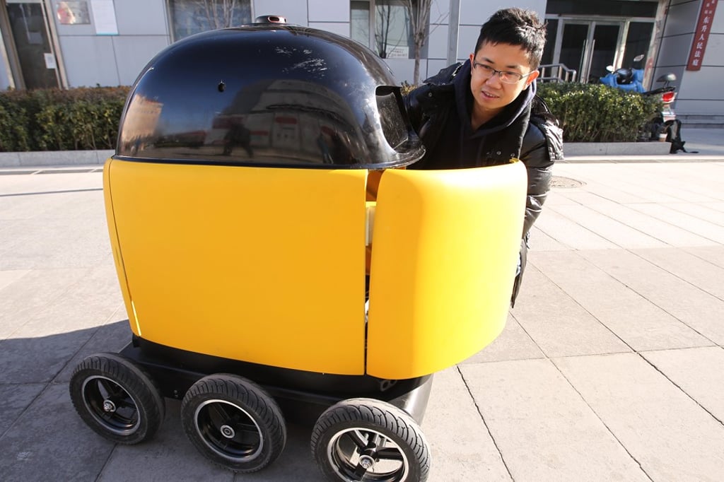 Li Hing-lung, co-founder of ZhenRobotics, is pictured with a delivery robot he and his team invented that he hopes could some day replace delivery workers in China, on December 21, 2017, in Beijing. Photo: SCMP/Simon Song