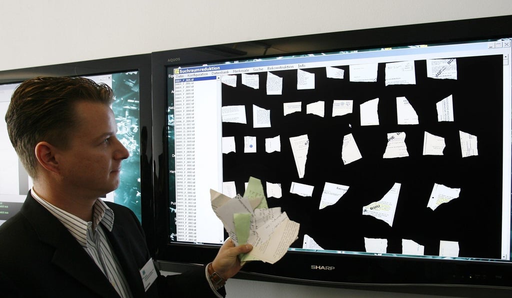 Jan Schneider of Germany's Fraunhofer Institute demonstrates efforts to reconstruct shredded Stasi files in Berlin in this 2007 file photo. Photo: AP