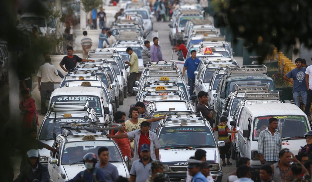 Taxis wait for fuel at a service station in the Nepalese capital Kathmandu in October 2015, with the landlocked nation hit by an acute shortage of petroleum products and other essential commodities after India stopped supplies. Photo: EPA